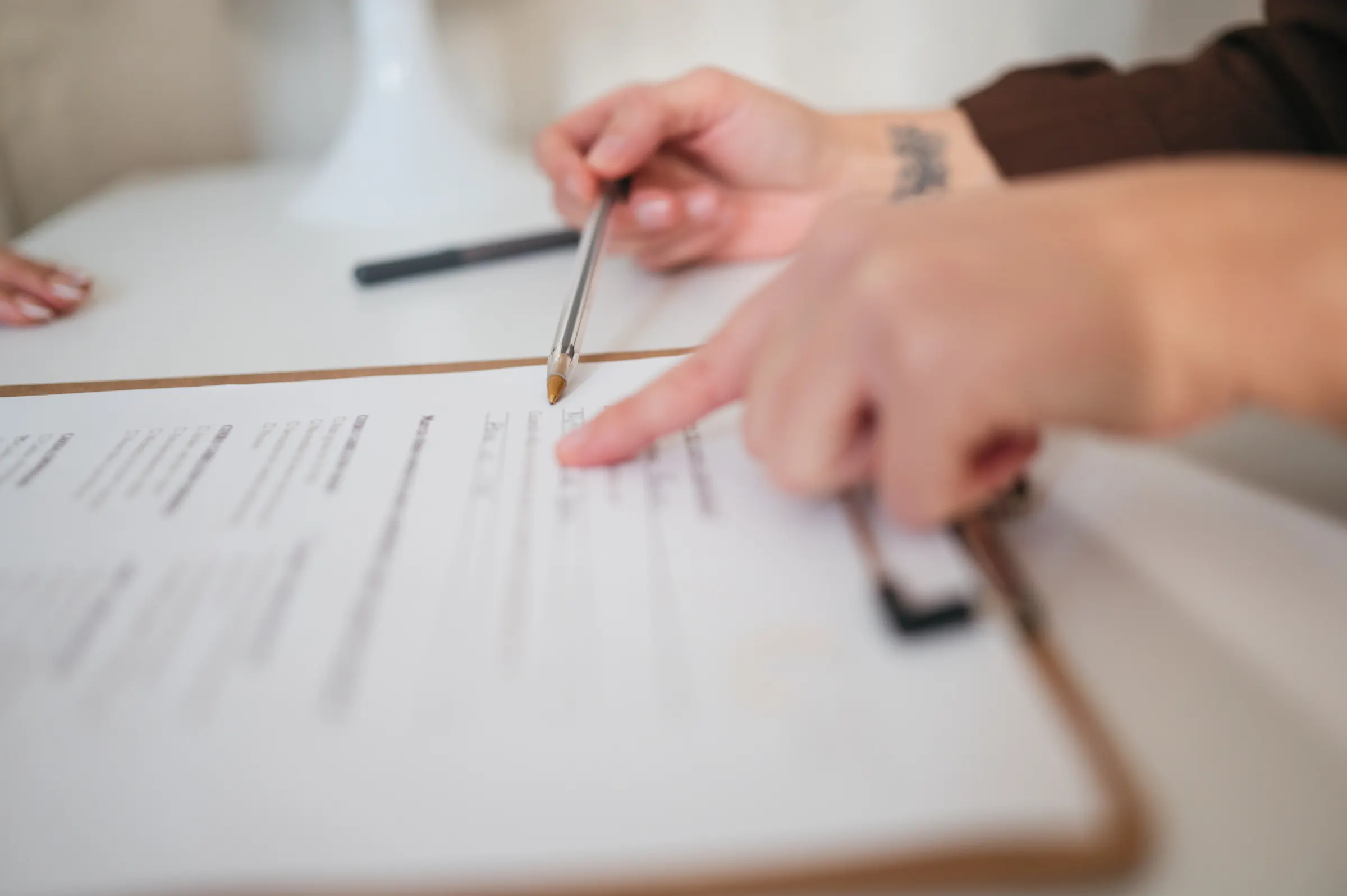 Hands reviewing a printed document together at a table