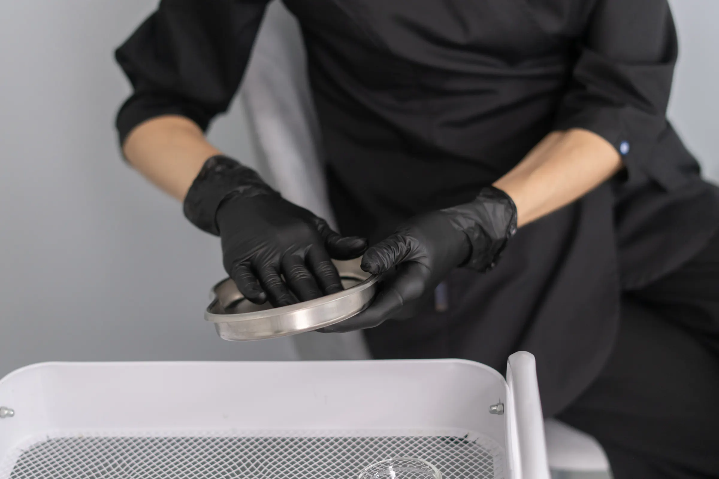 Gloved provider hands preparing a treatment tray