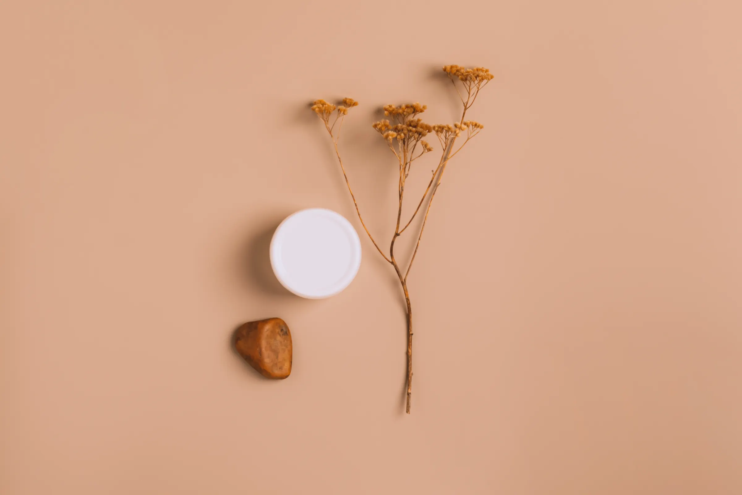 Minimal skincare still life on a neutral surface